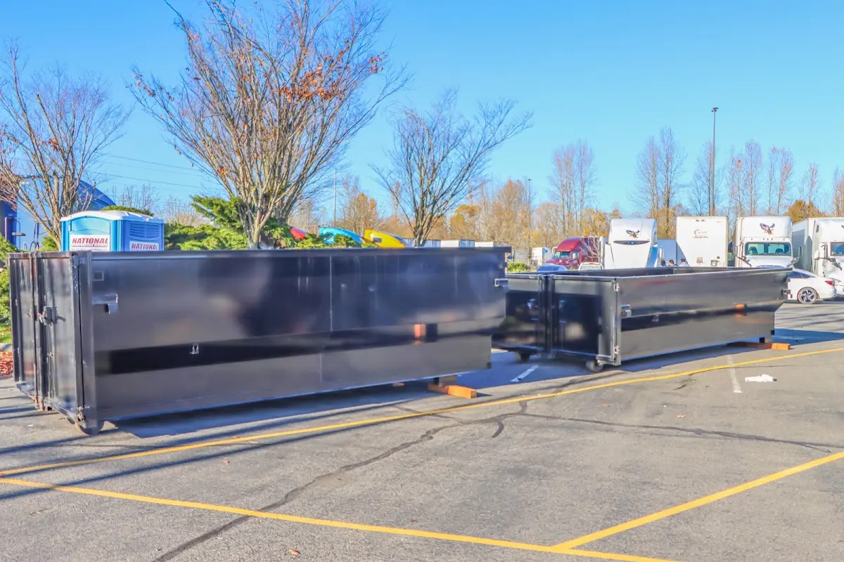 Professional dumpster rental service with roll-off container on residential driveway in Fitzgerald